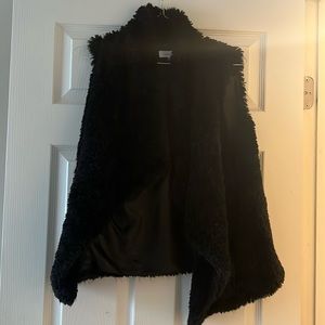 Black faux fur vest.